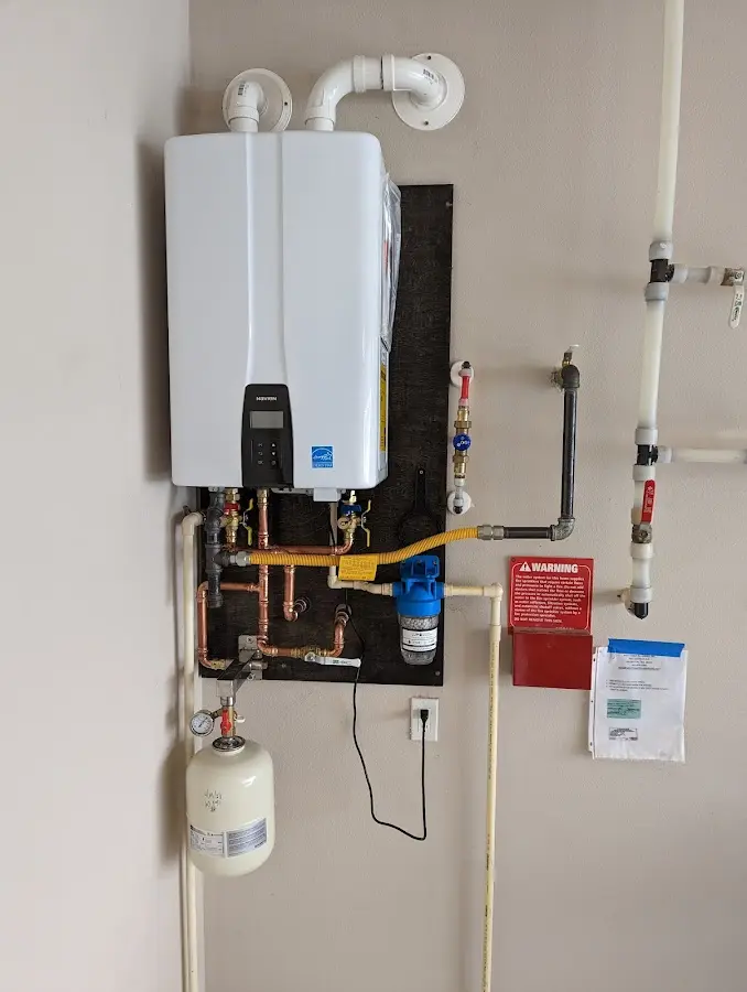 Professional plumber installing copper piping in a New Lenox home